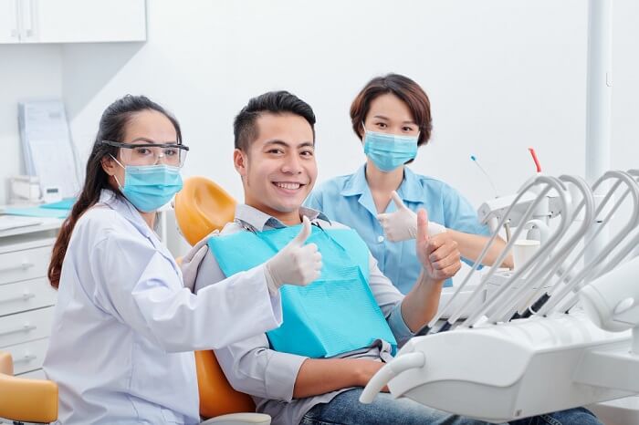 happy-smiling-handsome-asian-man-his-dentist-assistant