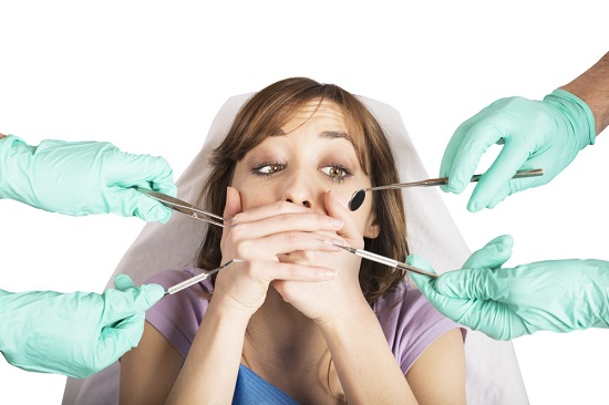 girl-frightened-by-dentists-covers-her-mouth